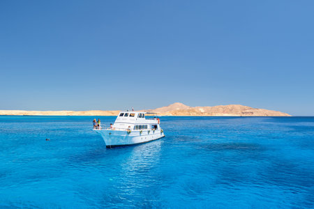 View from the shore to the sea with yachts that set sail.