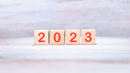Wooden cubes with the inscription 2023 on a light background