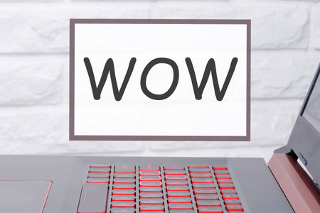 WOW an inscription on a magnetic board hanging on a brick wallの写真素材