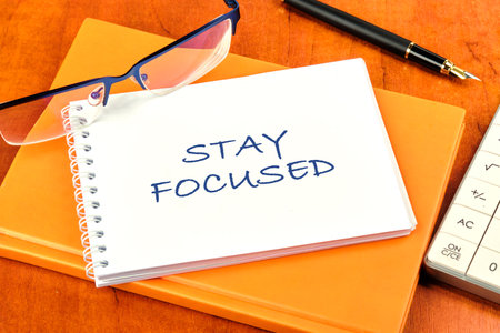 Motivation concept. STAY FOCUSED written on a clean white notebookの写真素材