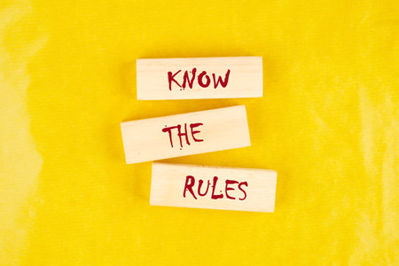 Know the Rules text on wooden blocks on a yellow backgroundの写真素材