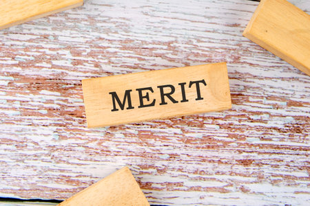 Merit word written on wooden blocks on old boards. Business conceptの写真素材