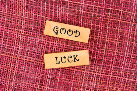 GOOD LUCK symbol on wooden blocks on a mesh backgroundの写真素材
