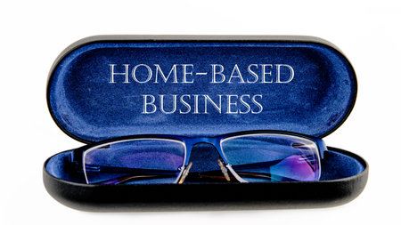 Text Home based business on an open case with eyeglassesの写真素材
