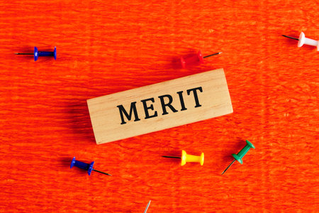 Merit word written on wooden blocks. Bright background. The concept of business and brand. Space for copying.の写真素材
