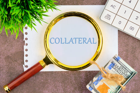 Business and finance. The inscription - COLLATERAL written through a magnifying glass on a piece of...