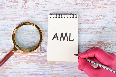 AML Anti Money Laundering Finance Business Concept. handwritten description in a notebook