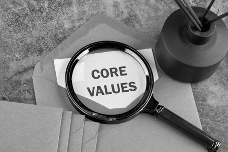 CORE VALUES. ethics concept, text through a magnifying glass on a piece of paper sticking out of an envelope. Classified informationの写真素材