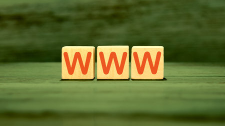 WWW written on wooden cubes on green saturated backgroundの写真素材