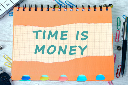 Business concept. Copy space. The words TIME IS MONEY on a piece of torn-off sheet of a checkered...