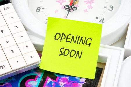 Opening soon inscription on a yellow sticker on the background of the clock