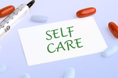The self word care. health care concept. health and beauty concept. SELF CARE on the business card next to pills, vitamins and a syringe