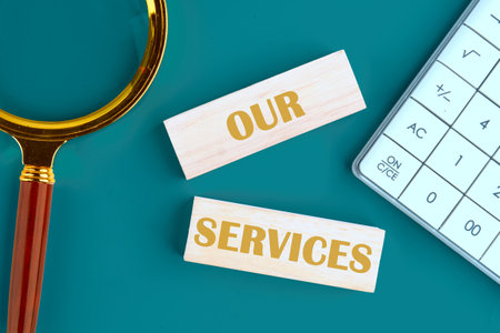 Business concept The text OUR SERVICES on wooden blocks in a composition with a magnifying glass and...