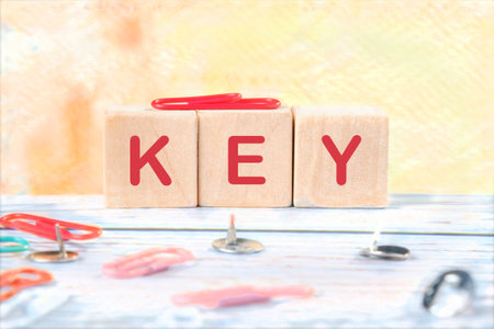 KEY WORD word on wooden cubes on a yellow background