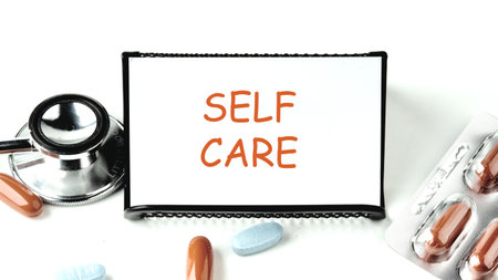 The self word care. health care concept. health and beauty concept. SELF CARE on a white business card on a stand on a white background.