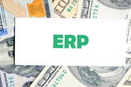 ERP - Enterprise resource planning theme. Concept word ERP on a white business card against a...