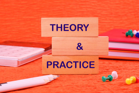Theory and practice education profession. THEORY and PRACTICE on a wooden block in a composition...