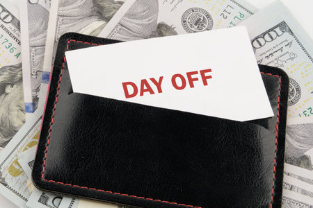 Business and Day off concept. Copy space. DAY OFF symbol on a business card in a black leather...