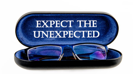 Expect the unexpected motivational phrase symbol on the inside of the glasses case on a white backgroundの写真素材