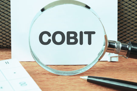 Control Objectives for Information and Related Technologies. COBIT through a magnifying glass on a white sheetの写真素材