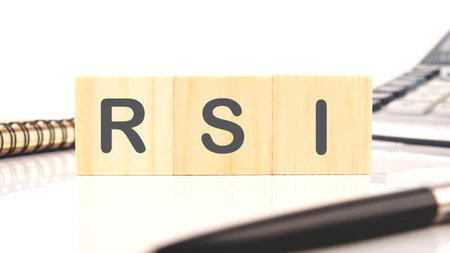 Word RSI on wooden cubes on a white background in a composition with a notebook, pen and calculator