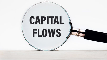 Business concept. The inscription Capital Flows text appeared looking at a white background through...