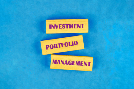 Text INVESTMENT PORTFOLIO MANAGEMENT on blocks made of wood, top view Conceptual photo