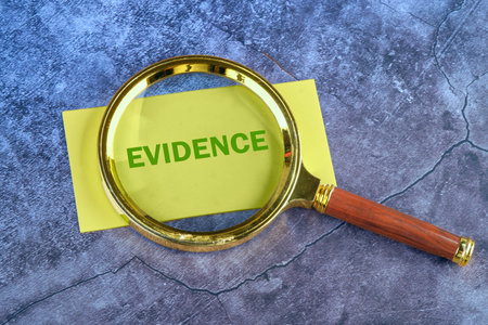 Business and finance concept. The inscription - EVIDENCE through a magnifying glass to a yellow...