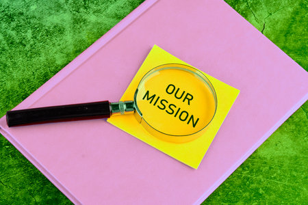 Concept Business and Our Mission concept. Copy space. Word Our Mission through a magnifying glass on...