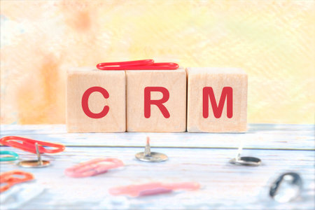 CRM Customer Relationship Management for business. CRM database analysis. CRM it is made of wooden cubes on a colored backgroundの写真素材