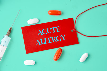 ACUTE ALLERGY words on a red card in a composition with tablets, vitamins and a syringe.の写真素材
