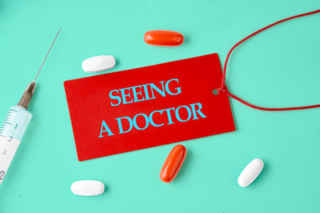 Medical concept. The inscription SEEING A DOCTOR words written on a red card in a composition with...
