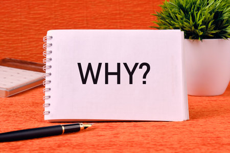 Start with Why Business Motivation Concept. Word WHY on a blank notepad page on an orange backの写真素材