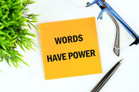 WORDS HAVE POWER TEXT written on a sticker on a white background, top viewの写真素材