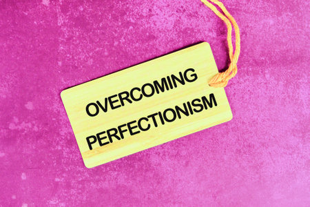 Business Overcoming perfectionism concept. Copy space. Concept words Overcoming perfectionism on a card with a rope on an abstract backgroundの写真素材