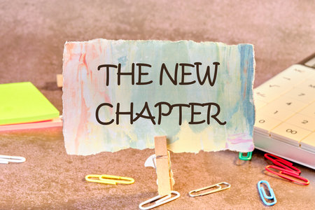 Conceptual the new chapter symbol. Copy space. The new chapter words written on a piece of paper in a clothespinの写真素材