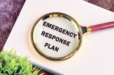 ERP as EMERGENCY RESPONSE PLAN written through a magnifying glass in a business record bookの写真素材