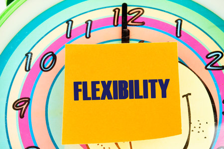 Business flexibility concept. Copy space. Flexibility symbol. Concept word Flexibility on the sticker on the background of the clock face with handsの写真素材