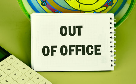 OUT OF OFFICE words written in the notebook, the front viewの写真素材