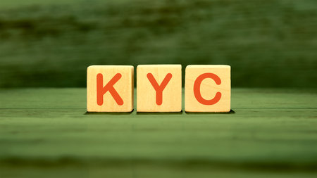 Business Acronym KYC Know Your Customer. KYC assembled from wooden cubes on a green backgroundの写真素材