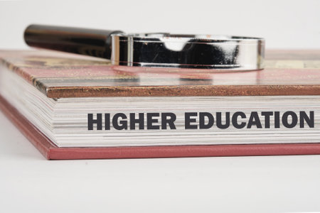 Inscription HIGHER EDUCATION on the end of the book in close-up