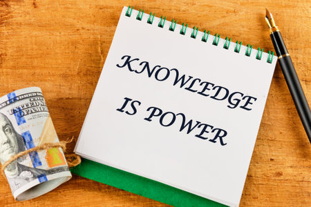 KNOWLEDGE IS POWER words on a blank sheet of notebook against a papyrus backgroundの写真素材