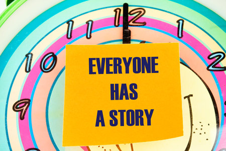 Business, technology, internet concept. EVERYONE HAS A STORY message written on the sticker on the background of the clock face with handsの写真素材