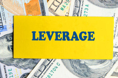 LEVERAGE text written on yellow paper against the background of American dollar billsの写真素材