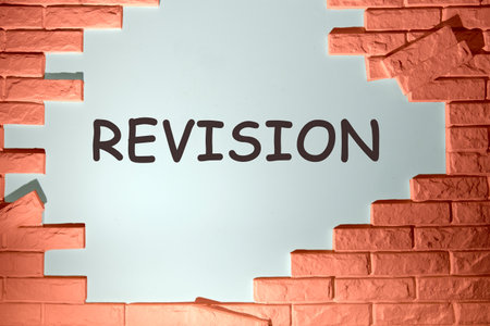 REVISION written on the wall under the dismantled bricksの写真素材