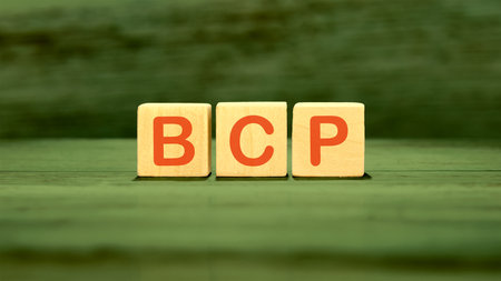 BCP Business Continuity Plan. BCP assembled from wooden cubes on a green backgroundの写真素材