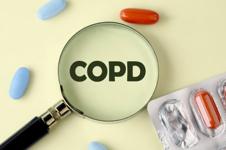 COPD word on a yellow background through a magnifying glass close-upの写真素材