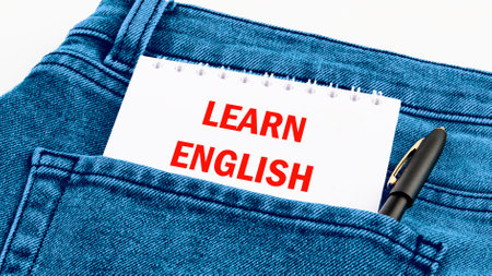 Learn English Text written on a notebook in red letters in jeansの写真素材