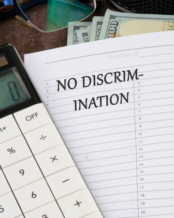 Conceptual no discrimination symbol. Copy space. No discrimination words written in a notebook in a ruler on a blank sheetの写真素材