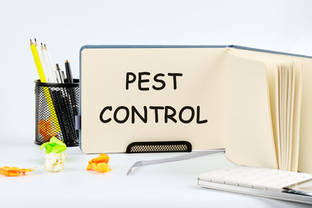 PEST CONTROL written on a blank sheet of notepad in the standの写真素材